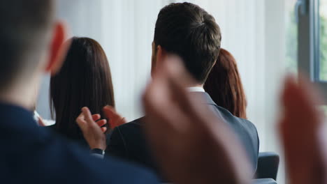 rear view of caucasian business people to the speaker at a conference