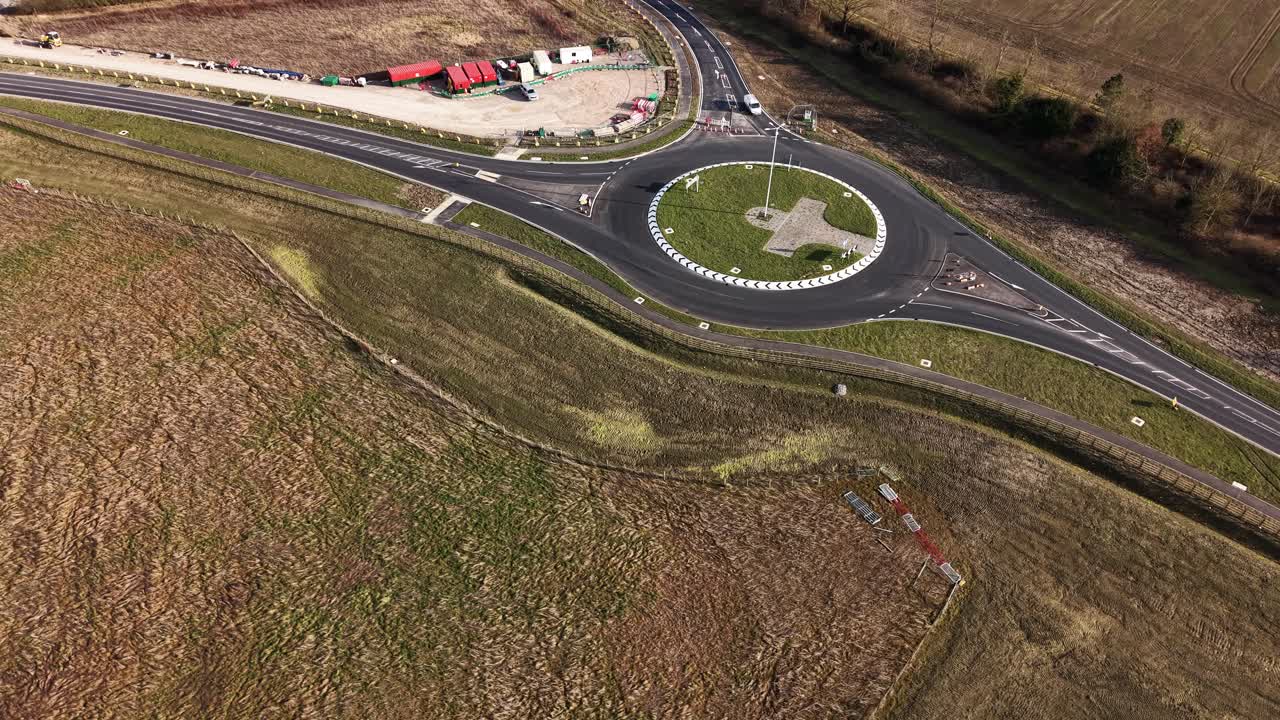 Aerial view of modern roundabout in Waddesdon, UK, contrast between rural surroundings and, engineered road design