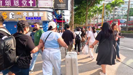 people crossing street near currency exchange shop