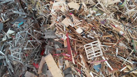 Aerial-Shot-Of-Discarded-Wood-And-Construction-Materials-At-A-Trash-Dump,-Landfill-Disposal