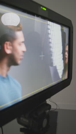 vertical video of female film director and watching actors rehearsing shooting movie or video in studio on monitor