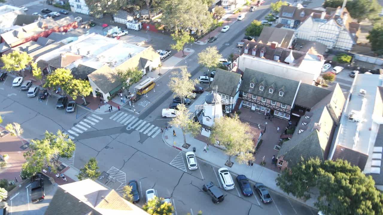 Aerial Flyback Reveal of Solvang Valley&rsquo;s Hamlet Square, in the golden glow of sunset at Hamlet Square, gradually revealing the enchanting entirety of Solvang Valley