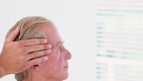 Physiotherapist-doing-head-massage-to-his-patient