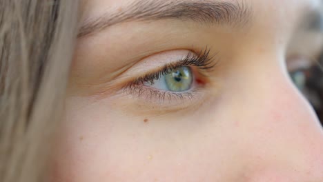 Closeup,-young-female-face-with-blue-green-eye,-without-make-up