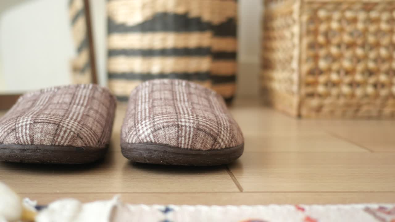 zapatillas de cuadros marrones en un piso de madera