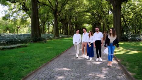 friends walking through a park alley