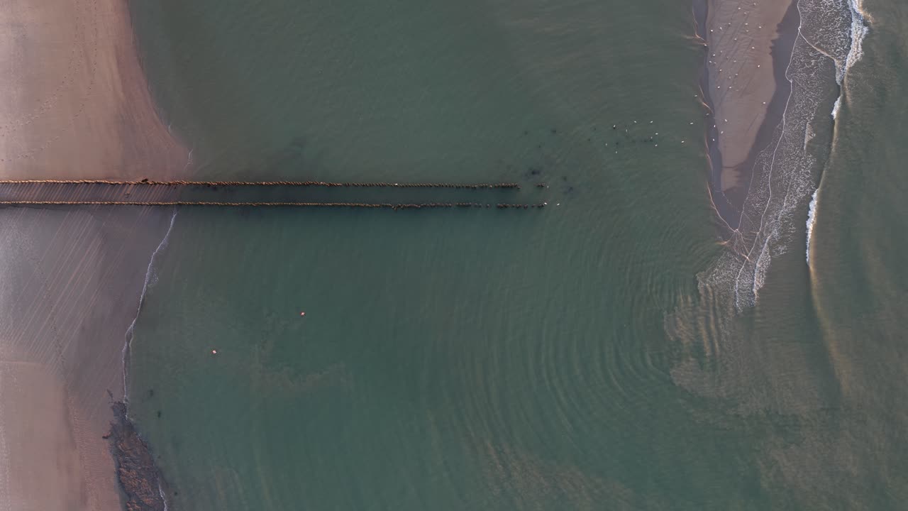 break waters top down view on sunset golden hour beach. The Sea. Aerial view