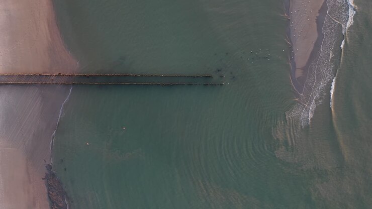 break waters top down view on sunset golden hour beach. The Sea. Aerial view