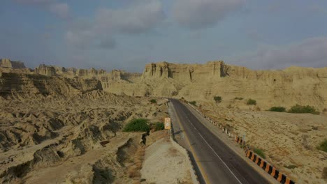 aerial over empty highway road through rugged hingol national park in balochistan desert landscape