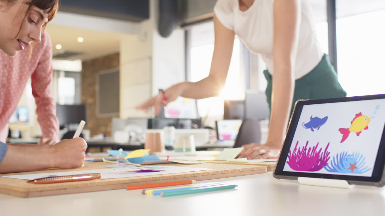 Collaborating on creative writing, team using sticky notes and tablet in office