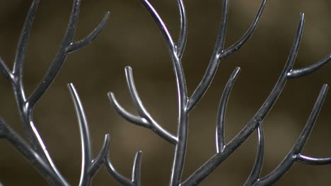 Black-plastic-antlers-rotating-on-turntable-with-golden-background