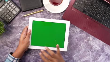 top view of businessman using digital tablet on office desk