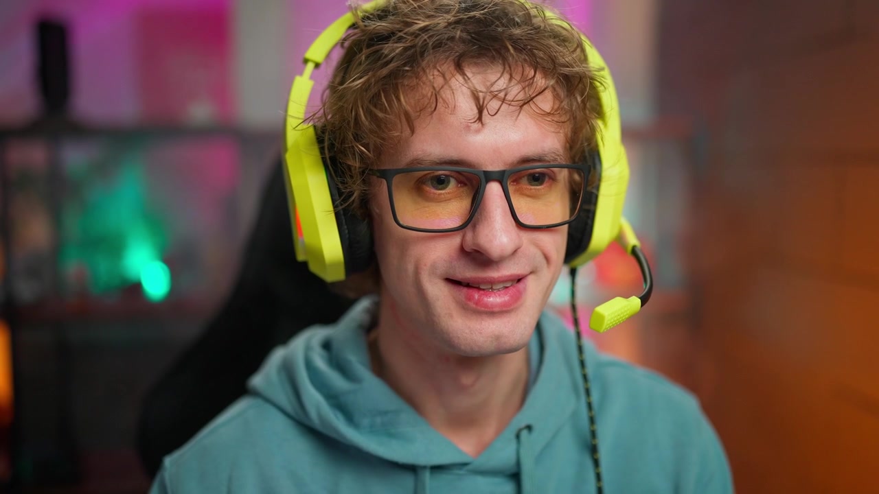Young Man Gaming and Talking with Headset at Computer