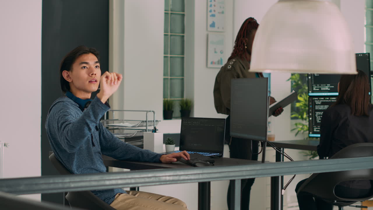 Programer typing source code on computer and turning head to use ar hologram