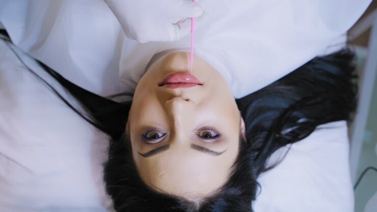 Make up for lips of woman. Young woman having makeup on lips at beauty salon