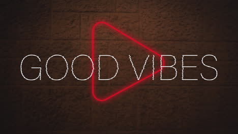 digital animation of good vibes text over neon red play icon against brick wall