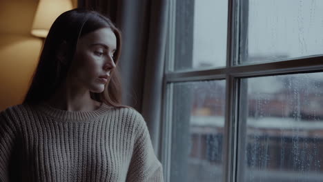 rainy day window views and a thoughtful woman