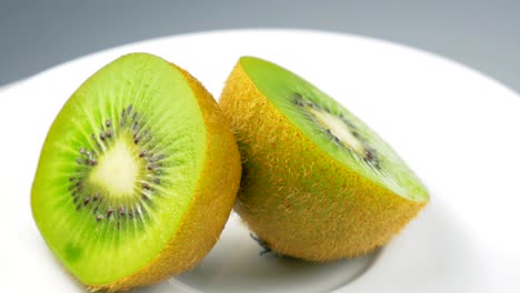 fresh kiwi slice is slowly rotating in the studio with the details.