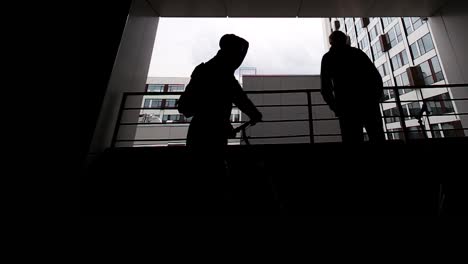 silhouette of people on rooftop balcony