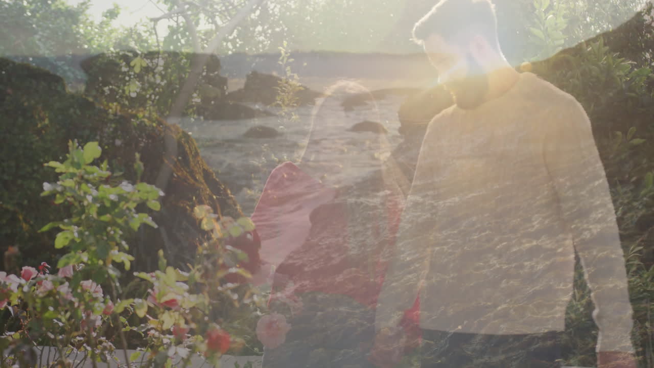 Walking through garden, couple enjoying sunlight with floral animation overlay