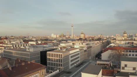 AERIAL:-Low-over-Berlin-Central,-Mitte-with-view-on-Alexanderplatz-TV-Tower-on-beautiful-sunny-day