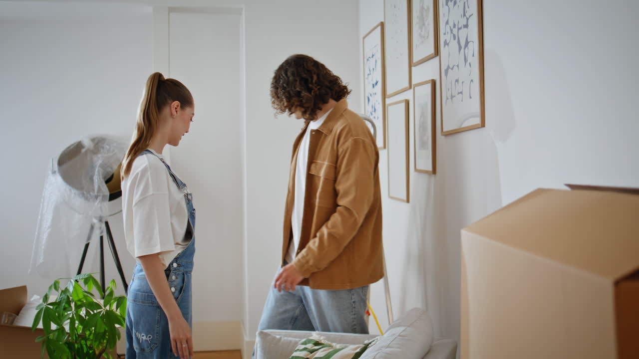 Smiling couple enjoy renovation new home decorating modern light living room