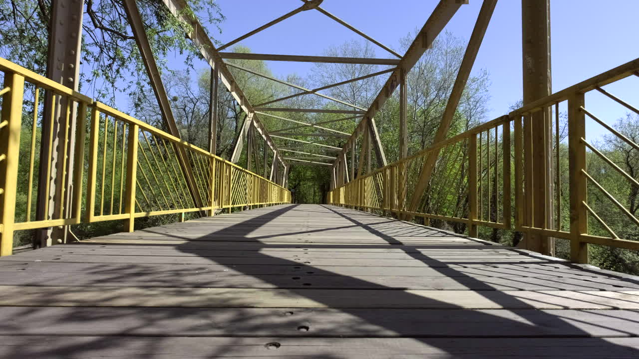 A slider move from left to right at a Bridge in Berlin Teltow. Direct sun is hitting the bridge which results in heavy shadows at the wooden ground.