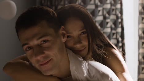 couple hugging in bedroom