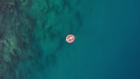 in summer the girl lies on the colorful seabed, the drone shoots upwards turkey