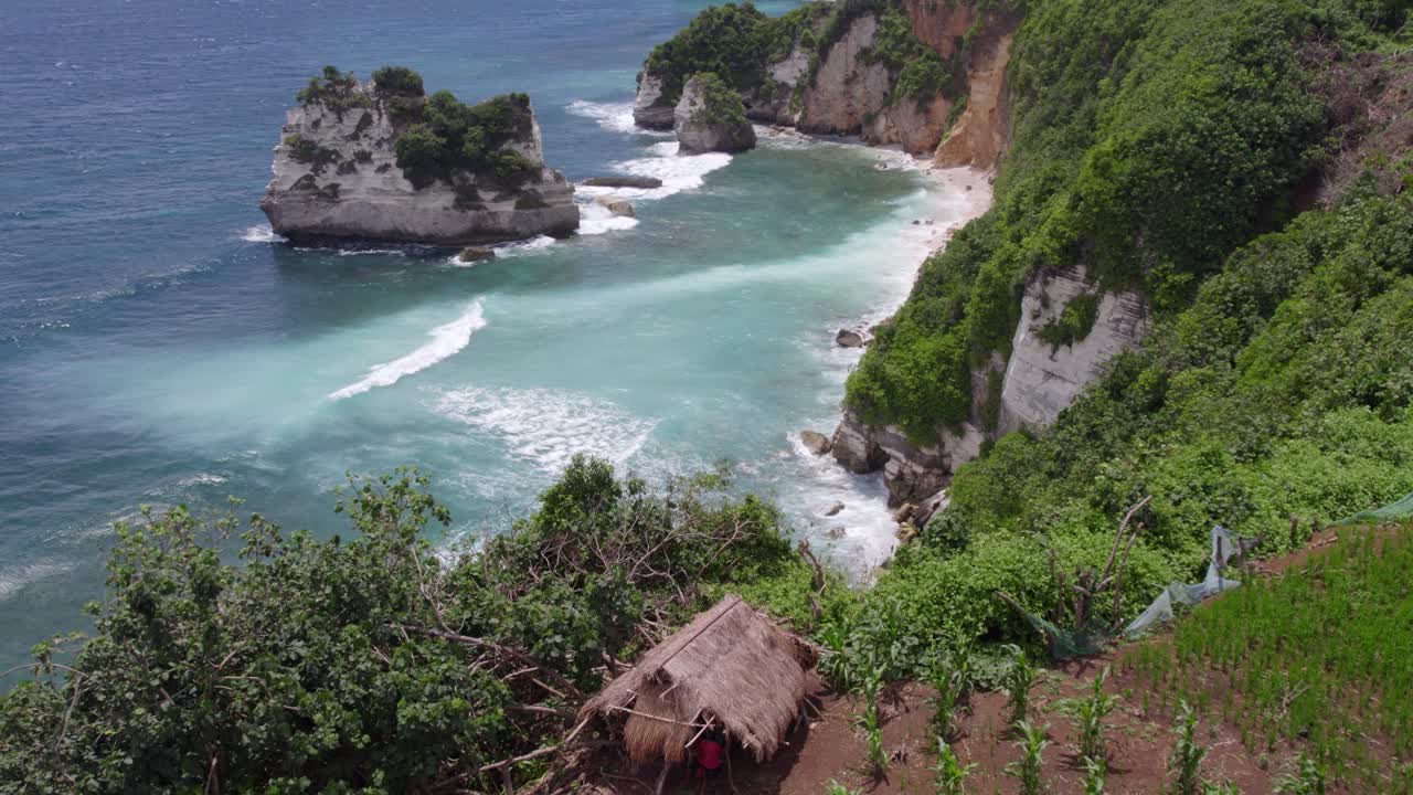 Reveal shot of charming small hut perched on a cliff at Sumba, aerial