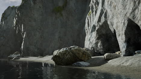 Rugged-rock-cliff-with-mountains-in-the-ocean