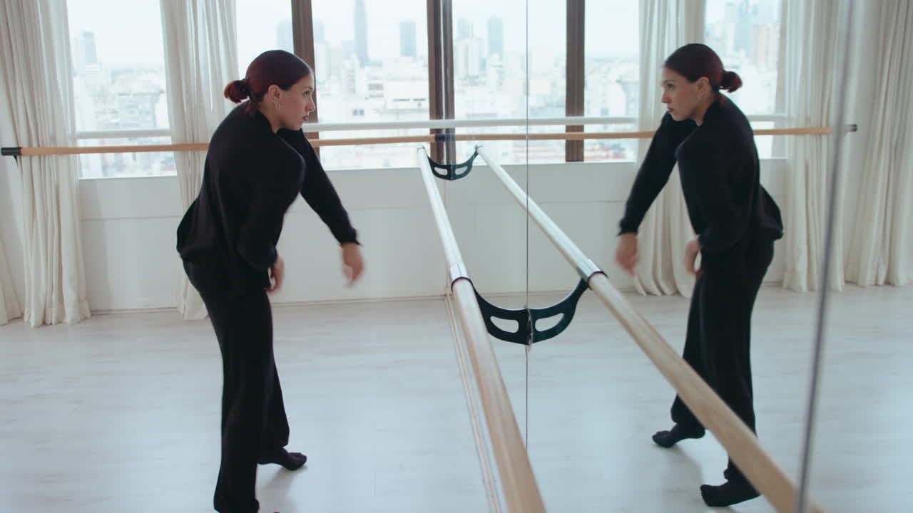 Professional Female Dancer Improvising in front of Mirror in Studio