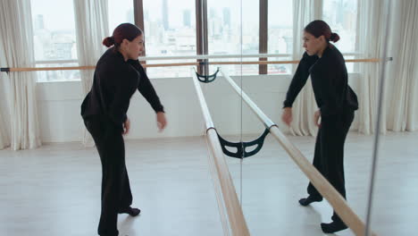 professional female dancer improvising in front of mirror in studio
