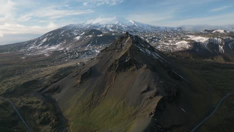 Beautiful-mountain-landscape-with-snowy-top,-surrounded-by-winding-road