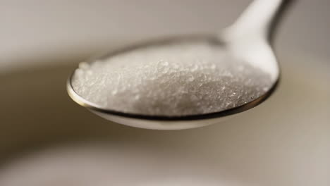 pouring sugar from a spoon