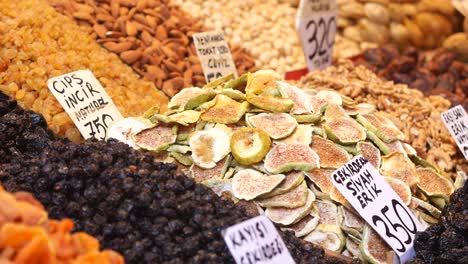 a hand reaching for dried figs at a turkish market