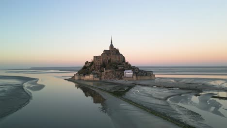 french ocean castle, mont saint michel cathedral, normandy france sunset, aerial drone trucking right to left establishing shot