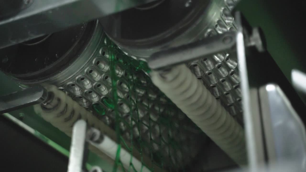 Pharmaceutical capsules aligned in modern mechanized dispensing system.