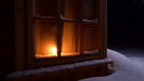 warm light through a snowy window at night