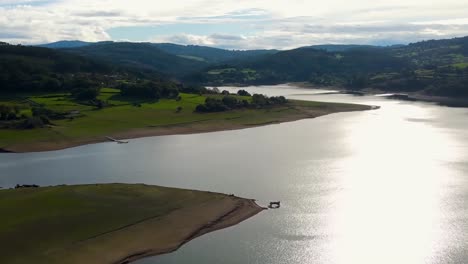 Embalse-De-Portodemouros-Con-Agua-Brillando-A-La-Luz-Del-Sol,-Rodeado-De-Exuberante-Vegetación-En-La-Coruña,-España