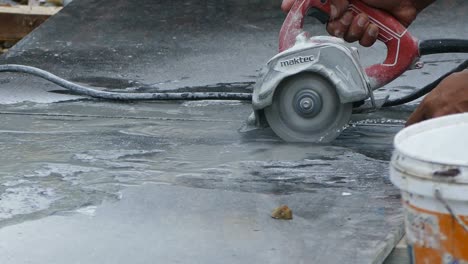 man cutting granite stone