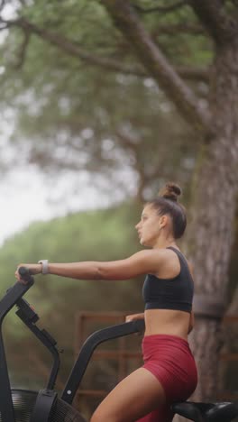 woman exercising on an air bike outdoors
