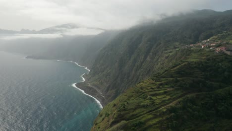 Incredible-lush-volcanic-mountains-elevated-above-Atlantic-Ocean-on-cloudy-day