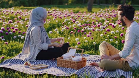 couple enjoying a picnic in a flower field