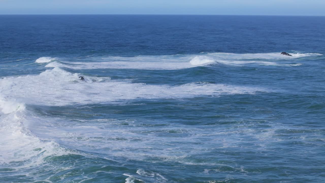 Slow Cinematic Drone Movement Over Vibrant Blue Waves Crashing