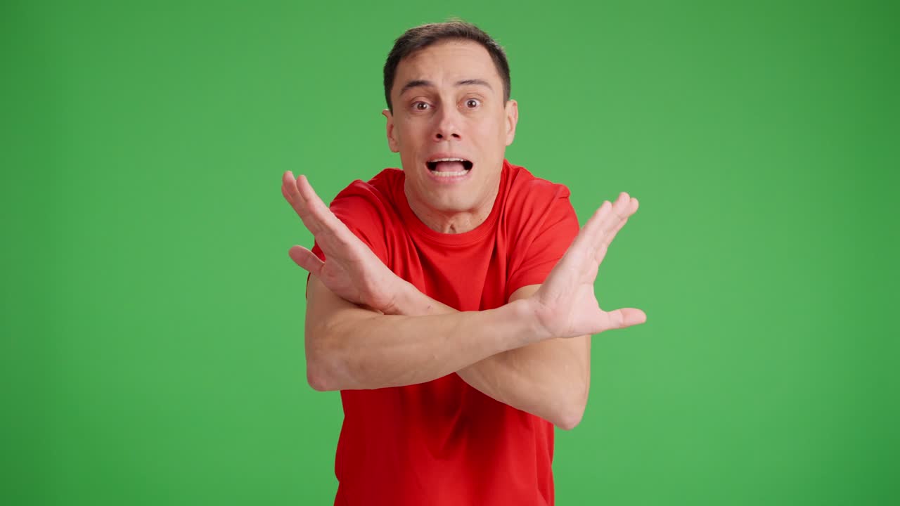 Man arguing with someone looking at camera, green screen background