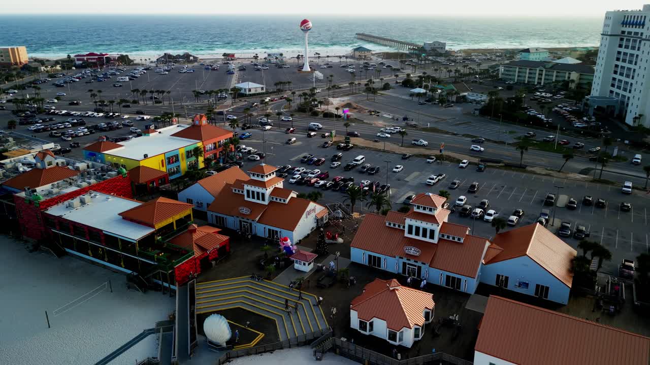 Aerial 4K drone view of Pensacola Beach from the Boardwalk, showing white sand, Gulf water, cars, traffic, and hotels in the distance. Perfect for travel and coastal footage. Shot on DJI Mini 3 Pro