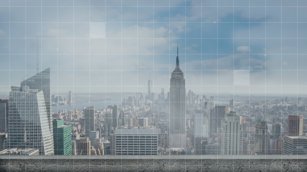 Empire State Building rising behind rooftop ledge, showing faint grid overlay across urban skyline