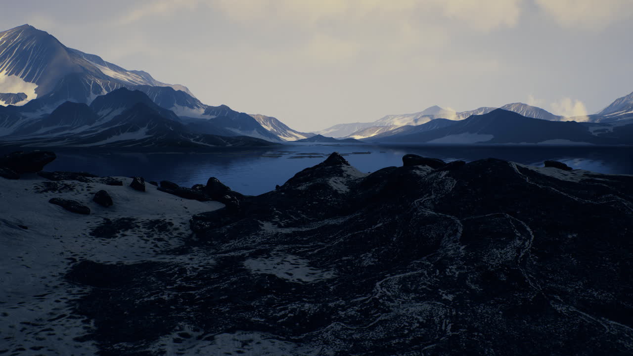 majestuoso paisaje montañoso que refleja aguas tranquilas bajo un cielo nublado
