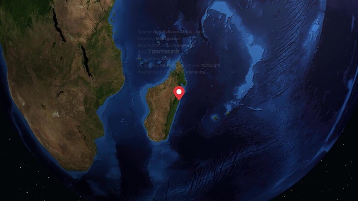 Digital globe rotates and zooms into Madagascar, displaying city information and location pin overlay